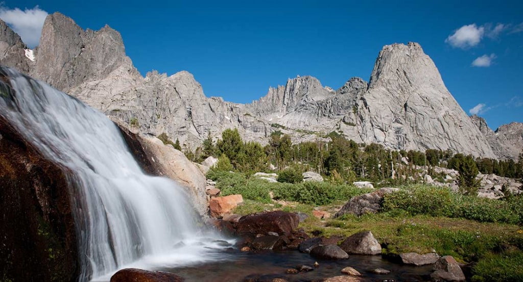 waterfall with peaks in the background