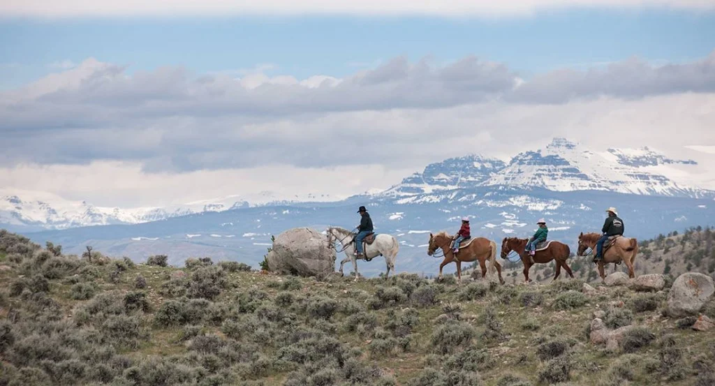 Horseback riders with the Absaroka Mountains in the background