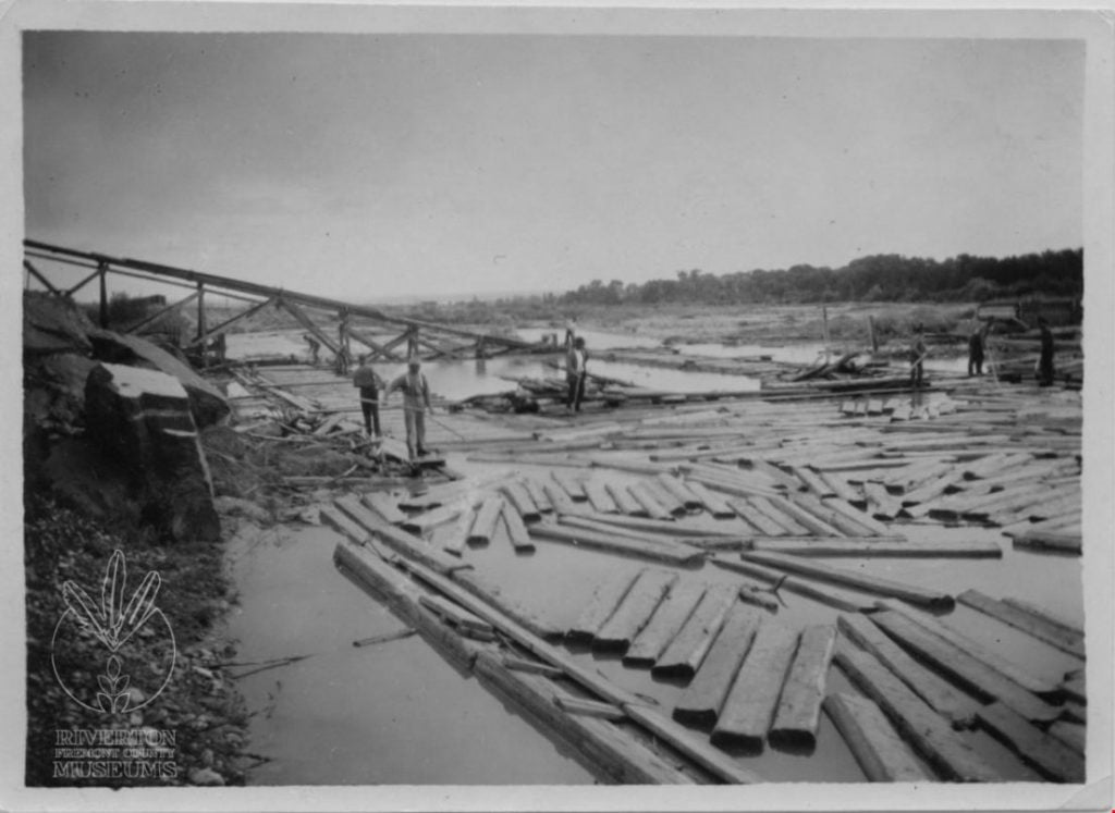 Image of tie hacks floating ties down the Wind River for use in building railroads. Photo courtesy of Fremont County Museums