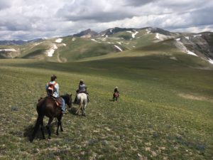 Women on horseback ride into a mountain adventure in Wyoming's Wind River Country