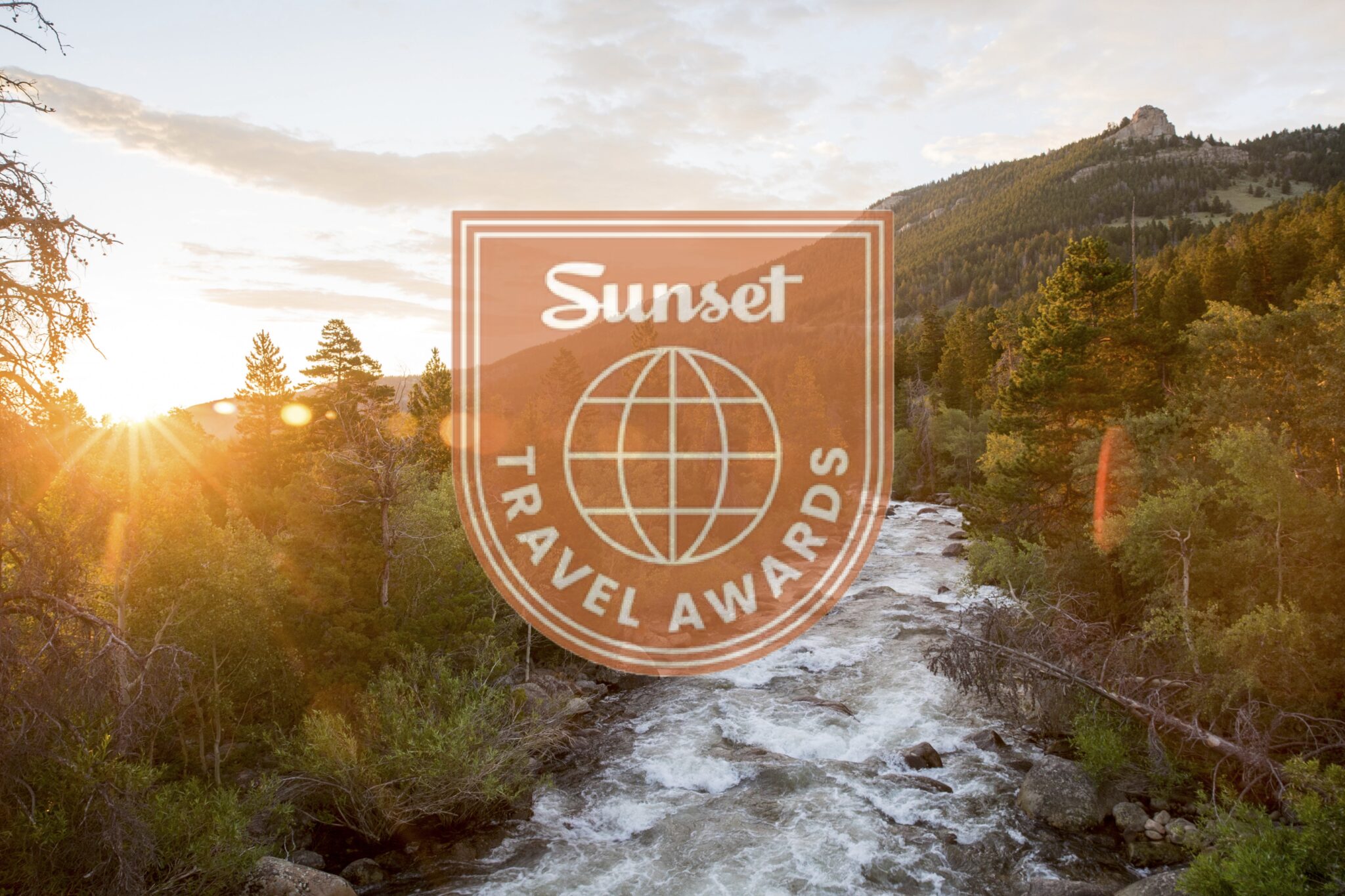 A serene mountain river at sunset, surrounded by lush forests and illuminated by the golden hour light in Wind River Country.