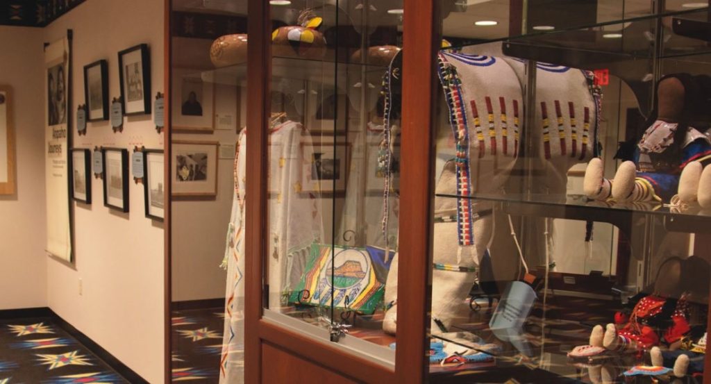 Display cases of traditional Northern Arapaho beadwork and artifacts in the Northern Arapaho Experience Culture Room.