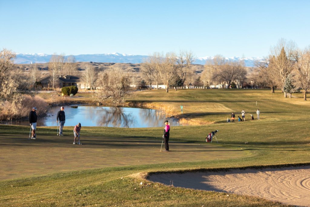 Golfers enjoying a sunny day at Riverton Country Club, one of the best things to do in Riverton, Wyoming, with beautiful scenic views and a relaxing atmosphere.