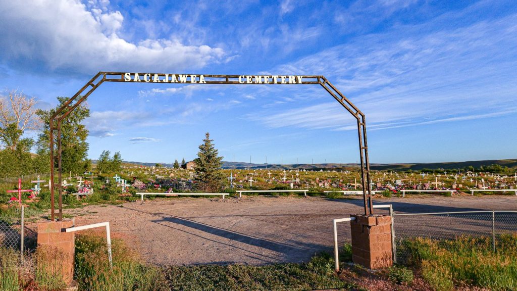 Sacajawea Cemetery on the Wind River Reservation, a historical landmark and one of the top things to do in the area, featuring colorful flowers and crosses.