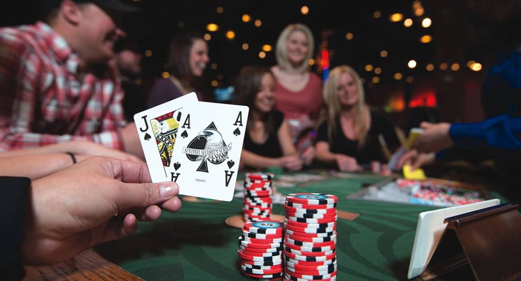 Guests enjoying a blackjack table at the Wind River Hotel and Casino, featuring poker chips and cards, a thing to do and attraction on the Wind River Reservation.