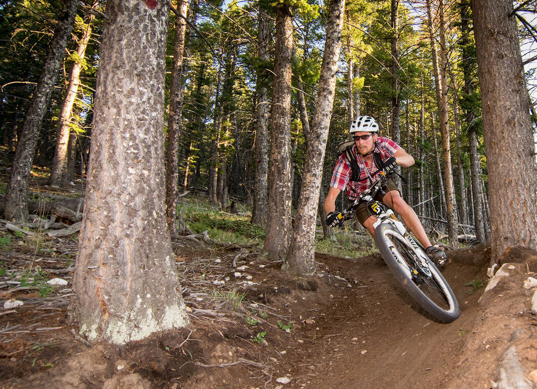 A person riding a bike on a trail.